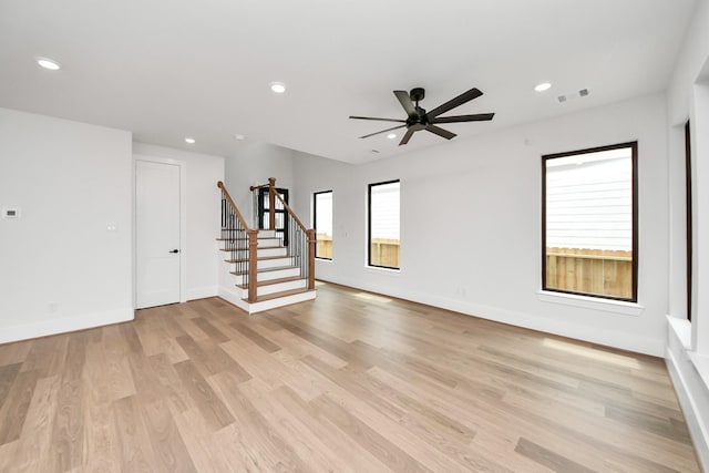 unfurnished living room with recessed lighting, stairs, light wood-style flooring, and visible vents