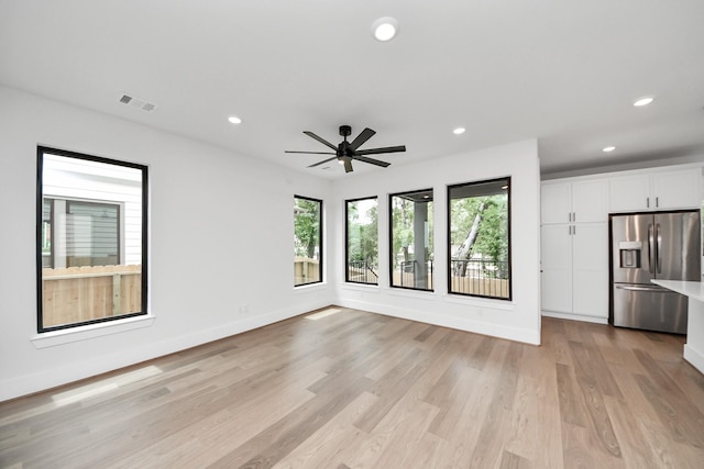 unfurnished living room featuring baseboards, recessed lighting, light wood-style flooring, and visible vents