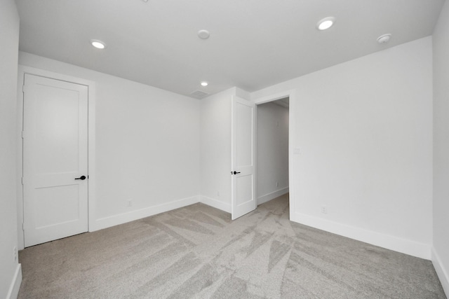 carpeted spare room with baseboards and recessed lighting