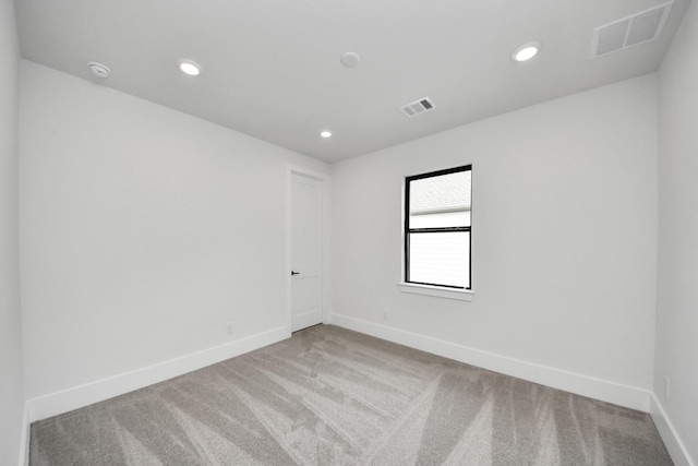carpeted spare room with baseboards, recessed lighting, and visible vents