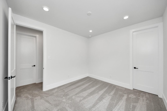 empty room with carpet floors, recessed lighting, and baseboards