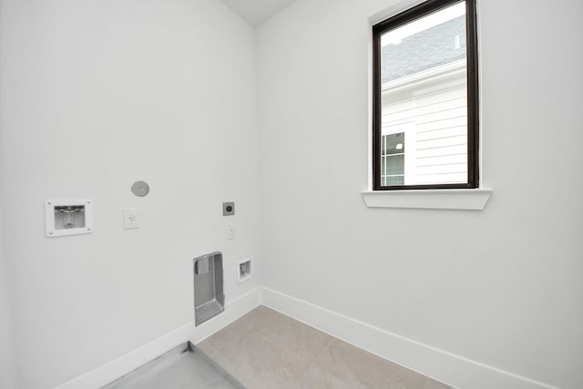 clothes washing area with electric dryer hookup, laundry area, baseboards, and washer hookup