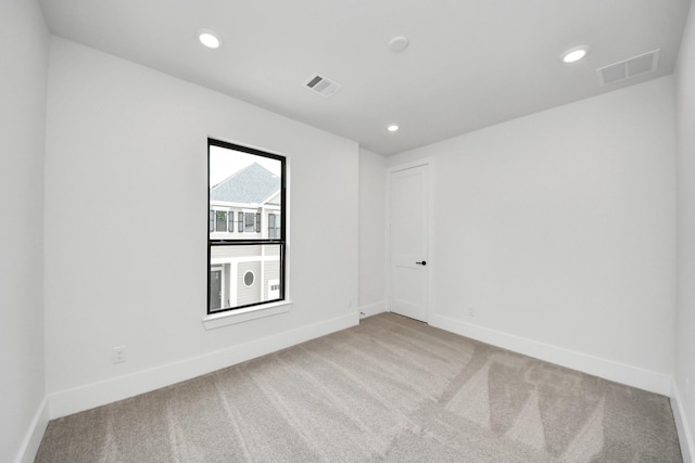 spare room featuring visible vents, baseboards, and carpet floors