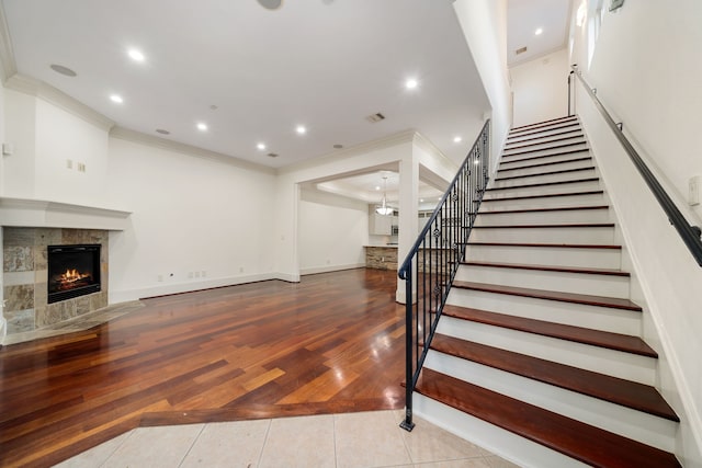 6115 Hamman St, Houston, TX 77007 - staircase featuring a fireplace, ornamental molding, recessed lighting, baseboards, and tile patterned floors