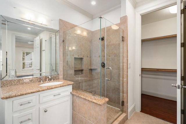 6115 Hamman St, Houston, TX 77007 - bathroom featuring crown molding, a stall shower, a walk in closet, tile patterned floors, and vanity