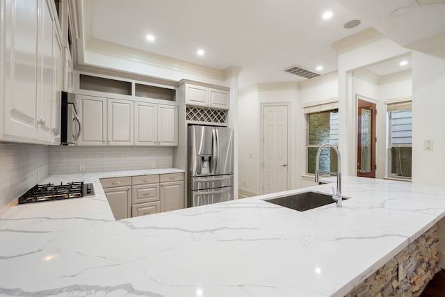 6115 Hamman St, Houston, TX 77007 - kitchen with stainless steel appliances, a sink, open shelves, light stone countertops, and backsplash