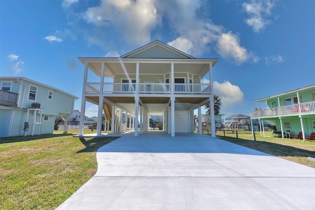 4206 Mason Dr, Galveston, TX 77554 - raised beach house featuring an attached garage, a carport, a front yard, and concrete driveway