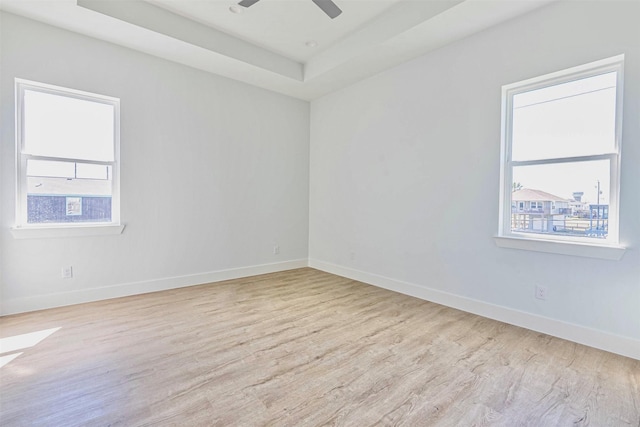 4206 Mason Dr, Galveston, TX 77554 - empty room featuring a ceiling fan, baseboards, wood finished floors, and a tray ceiling