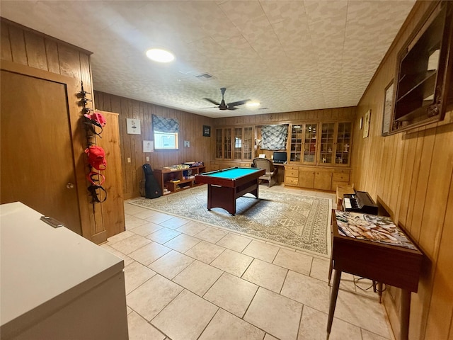 game room with visible vents, wood walls, ceiling fan, pool table, and light tile patterned floors