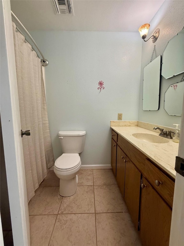 full bath featuring vanity, toilet, tile patterned floors, baseboards, and visible vents