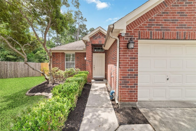 view of front of house featuring a garage, fence, a front lawn, and brick siding