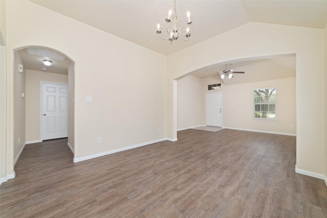empty room with arched walkways, wood finished floors, baseboards, ceiling fan with notable chandelier, and lofted ceiling