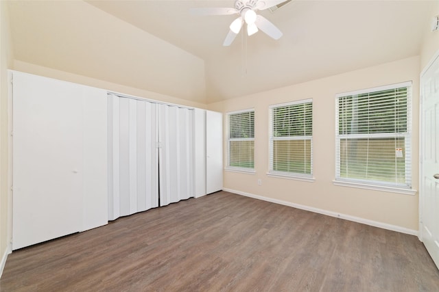unfurnished room with baseboards, ceiling fan, wood finished floors, and high vaulted ceiling
