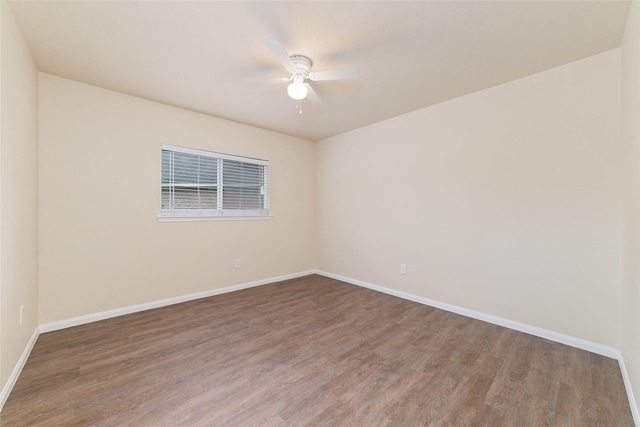 unfurnished room featuring baseboards, ceiling fan, and wood finished floors