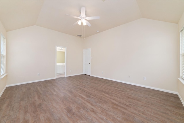 spare room with baseboards, a ceiling fan, vaulted ceiling, and wood finished floors
