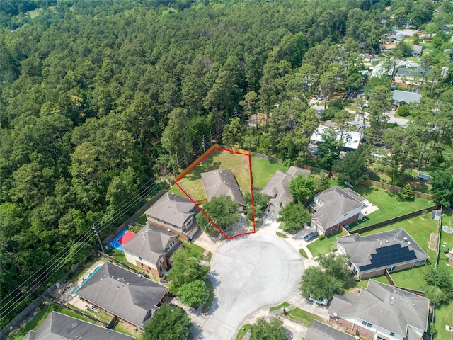 birds eye view of property featuring a forest view and a residential view