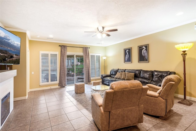 11068 First Lgt, Montgomery, TX 77356 - living room with ceiling fan, crown molding, tile patterned floors, baseboards, and a glass covered fireplace