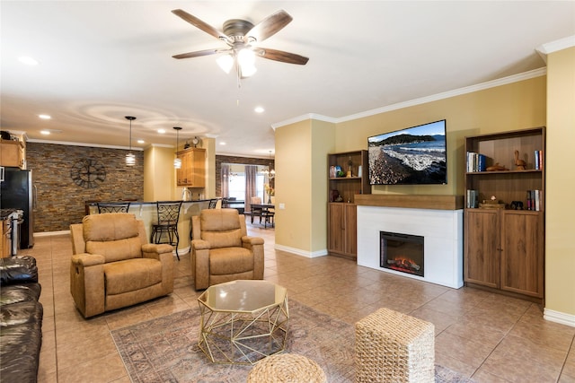 11068 First Lgt, Montgomery, TX 77356 - living area featuring ceiling fan, crown molding, light tile patterned floors, baseboards, and a warm lit fireplace