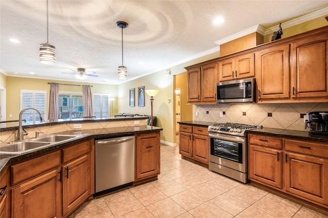 11068 First Lgt, Montgomery, TX 77356 - kitchen featuring pendant lighting, dark countertops, tasteful backsplash, a sink, and appliances with stainless steel finishes