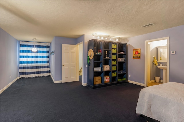 11068 First Lgt, Montgomery, TX 77356 - bedroom featuring visible vents, a textured ceiling, and baseboards