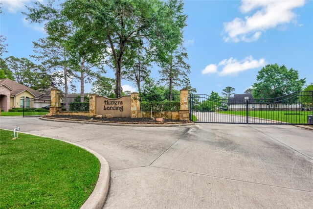 11068 First Lgt, Montgomery, TX 77356 - community / neighborhood sign featuring fence, a gate, a lawn, and driveway