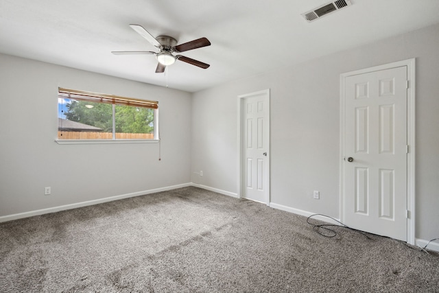 unfurnished bedroom with carpet flooring, baseboards, visible vents, and ceiling fan