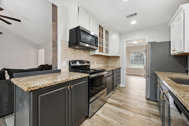 kitchen with ceiling fan, light wood-style floors, stainless steel appliances, white cabinetry, and visible vents