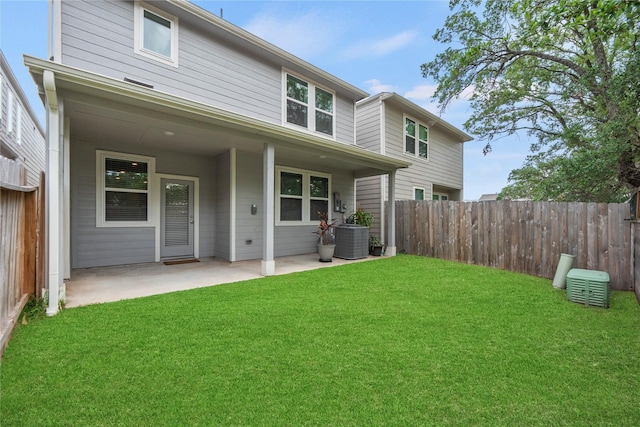 rear view of property featuring a patio area, fence, a yard, and cooling unit