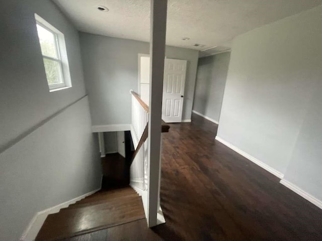 stairs with baseboards and wood finished floors