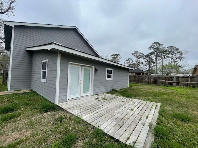 back of house featuring a yard, fence, a wooden deck, and french doors