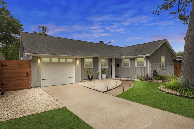 ranch-style home with fence, roof with shingles, board and batten siding, an attached garage, and driveway