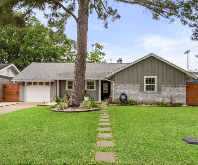 ranch-style home featuring brick siding, fence, a front lawn, concrete driveway, and an attached garage