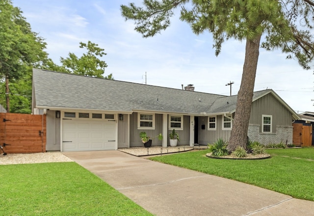 single story home with driveway, a front yard, roof with shingles, fence, and an attached garage