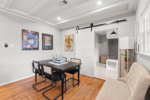 dining room featuring visible vents, a barn door, beam ceiling, light wood-style floors, and recessed lighting