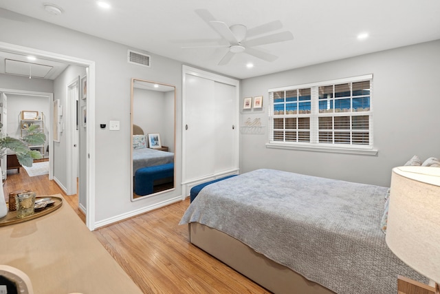 bedroom featuring recessed lighting, visible vents, wood finished floors, and attic access