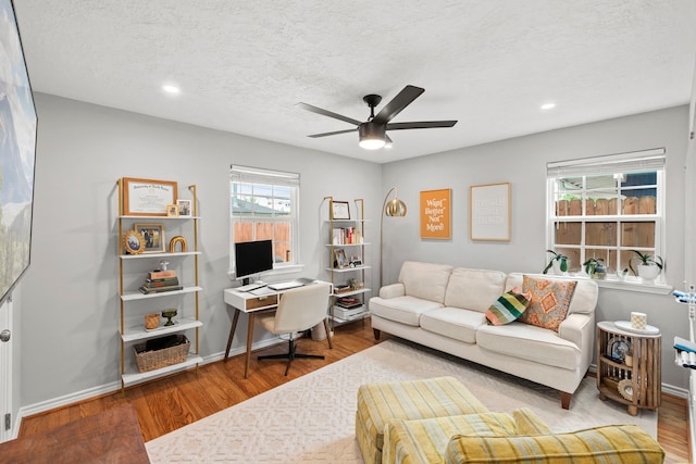home office featuring a textured ceiling, ceiling fan, recessed lighting, and wood finished floors