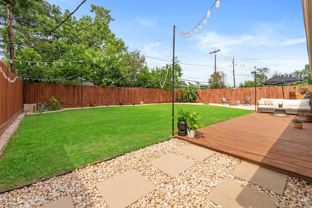 view of yard featuring a fenced backyard, outdoor lounge area, a patio area, and a deck