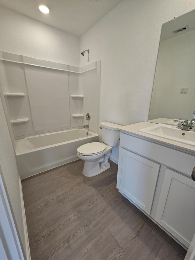 full bath featuring visible vents, shower / bathing tub combination, wood finished floors, and toilet