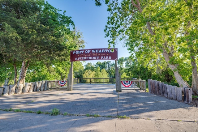 details featuring fence and a parking lot