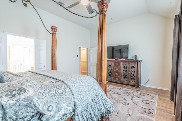 bedroom with baseboards, ceiling fan, wood finished floors, and high vaulted ceiling