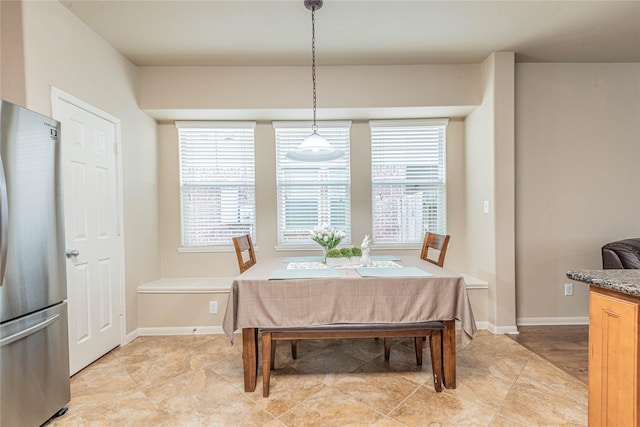 dining space featuring baseboards and a healthy amount of sunlight