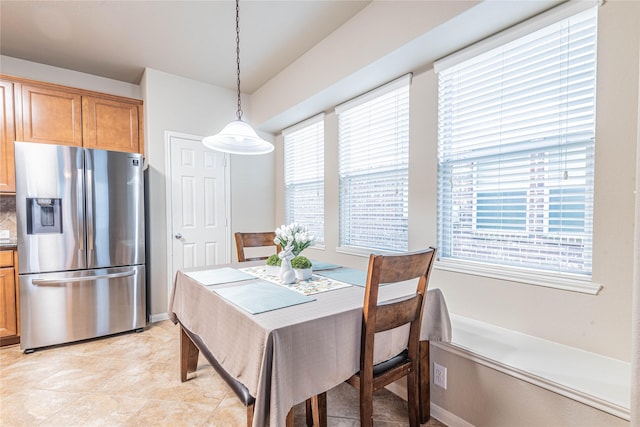 dining area with plenty of natural light and light tile patterned floors