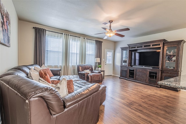 living room featuring ceiling fan, visible vents, a healthy amount of sunlight, and hardwood / wood-style flooring