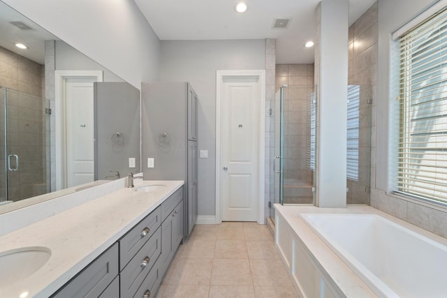 full bathroom featuring tile patterned flooring, a sink, double vanity, and a shower stall