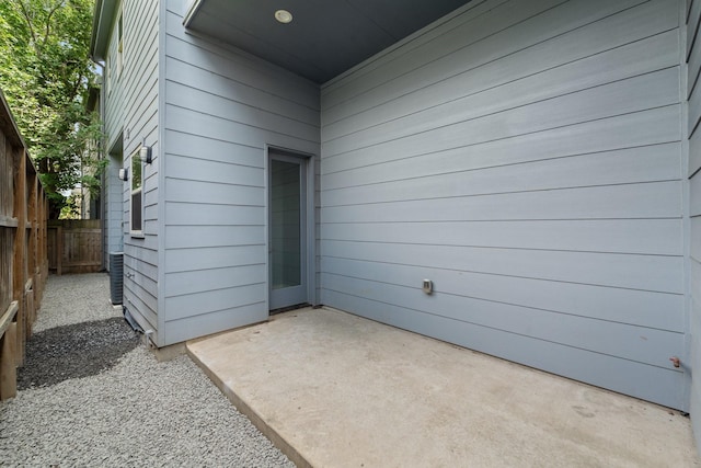 doorway to property featuring a patio area and fence