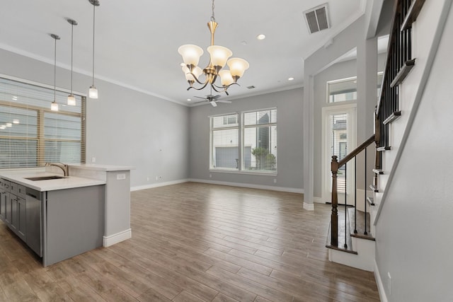 kitchen featuring visible vents, baseboards, a chandelier, a sink, and gray cabinetry
