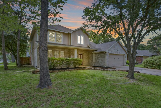 18307 Wild Lilac Trl, Humble, TX 77346 - traditional home with a front yard, a garage, brick siding, fence, and concrete driveway