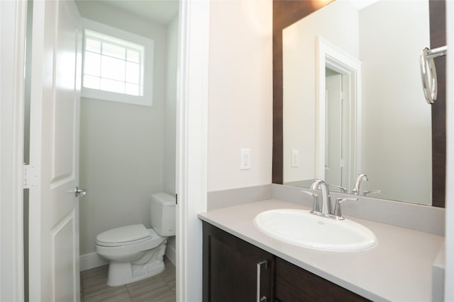 bathroom with vanity, tile patterned flooring, and toilet