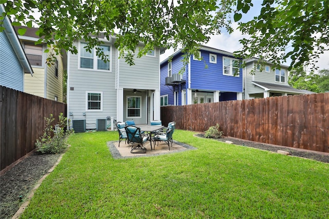 back of house featuring a fenced backyard, cooling unit, a patio area, a ceiling fan, and a yard