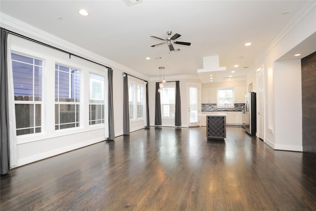 unfurnished living room with a ceiling fan, dark wood-style flooring, crown molding, baseboards, and recessed lighting